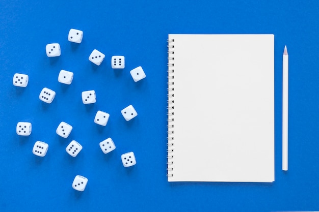 Free photo science of dice probabilities and empty notebook