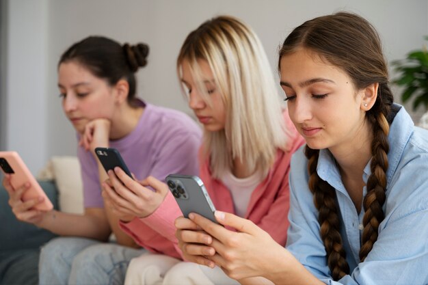 Side view girls holding smartphones