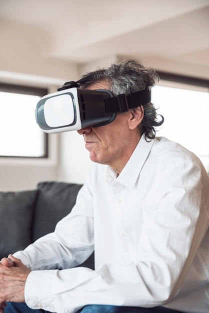 Side view of senior man using a virtual reality headset