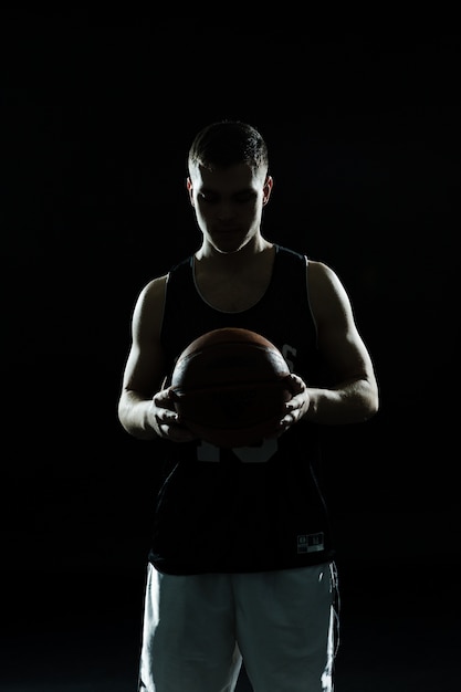 Silhouette of basketball player with ball