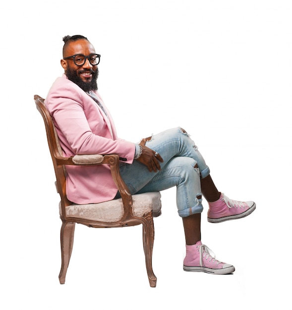 Free photo smiling man sitting on a chair