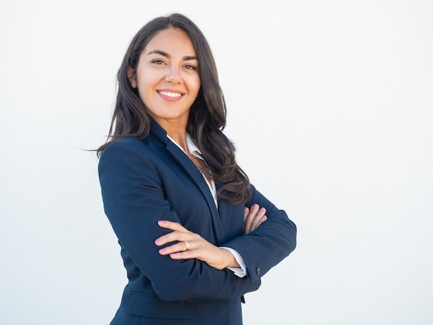 Free photo smiling confident businesswoman posing with arms folded