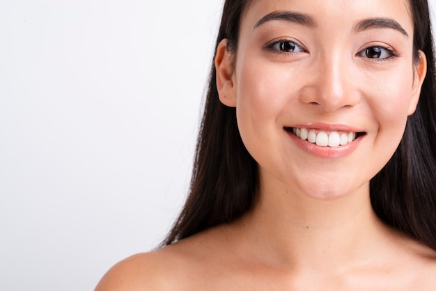 Smiling woman with healthy skin close up portrait