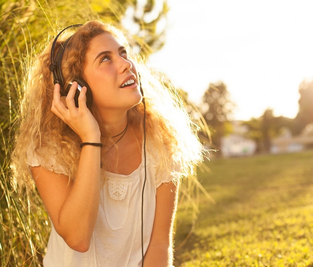 Photo gratuite jeune femme écoutant de la musique et levant les yeux