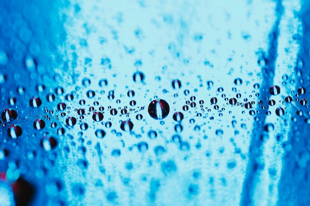 Photo gratuite verre réfléchissant bleu avec gouttelettes d’eau