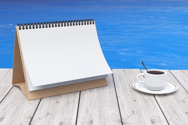 Photo calendrier vierge avec une tasse de café devant l'océan gros plan extrême. rendu 3d
