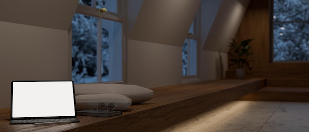 La maquette de l'écran blanc de la tablette numérique se trouve sur un long banc de fenêtre en bois dans le salon moderne