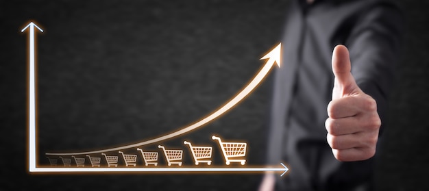 Zdjęcie koszyk zakupów i wykres wzrostu. wzrost sprzedaży