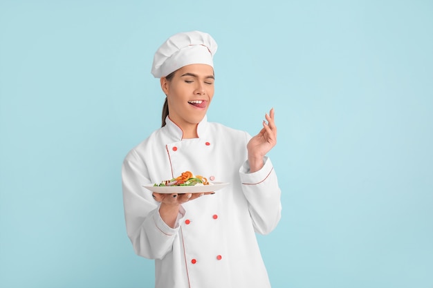 Шеф-повар-трансгендер с салатом на цветном фоне
