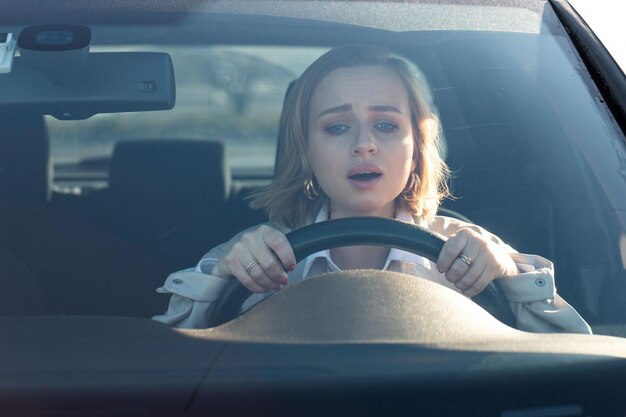 Photo woman drives car for  first time tries to avoid car accident very nervous scared worries