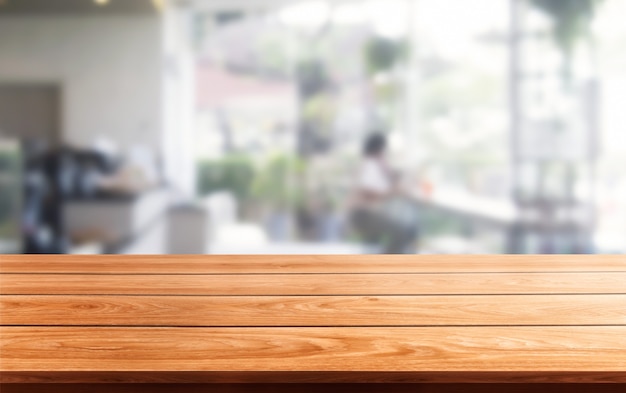 Photo wood table in blurry of modern restaurant room or coffee shop for product display mockup.