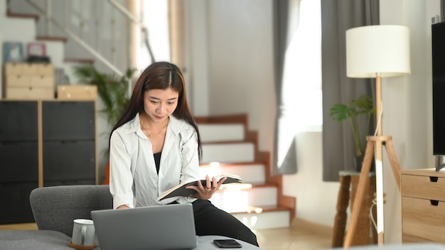 Young Asian woman working from home on a laptop