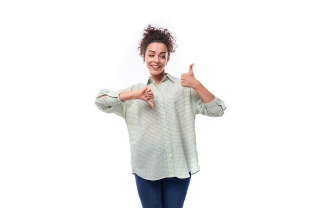 Photo young caucasian brunette woman with curly hair dressed in a shirt actively gesticulates