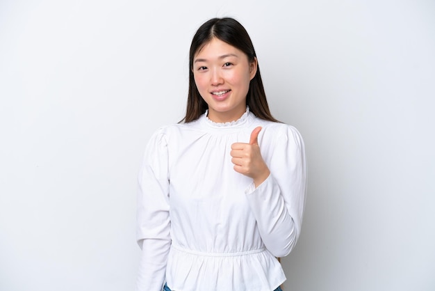 Young Chinese woman isolated on white background giving a thumbs up gesture