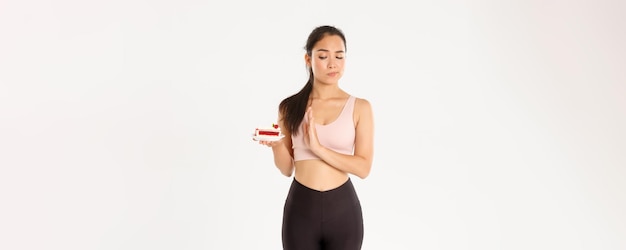 Active lifestyle fitness and wellbeing concept determined asian girl athlete rejecting sweets quit e