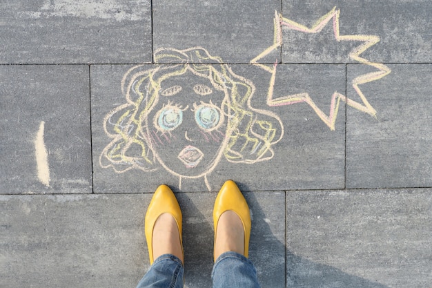 Абстрактный поп-арт женское лицо, картина написана на сером тротуаре