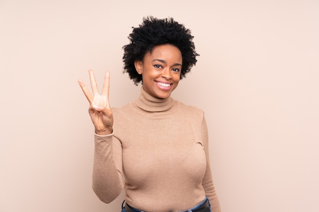 Photo african american woman happy and counting three with fingers