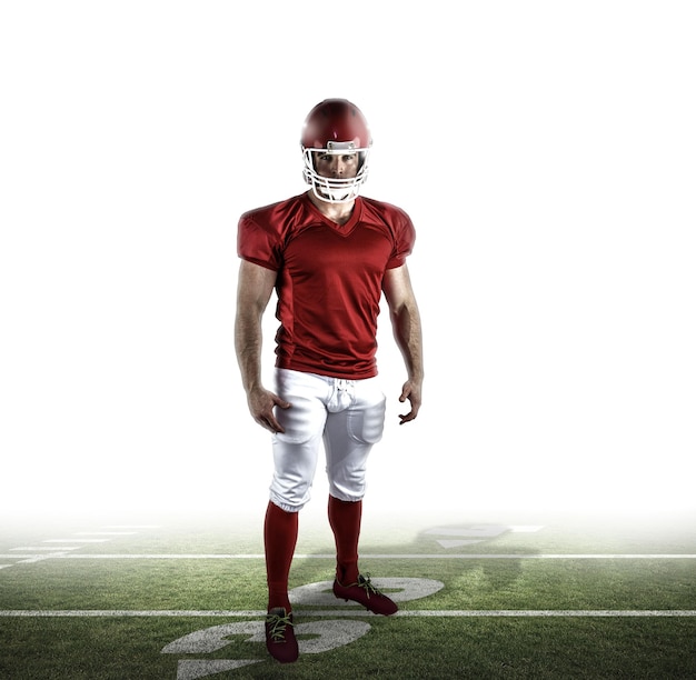 Photo american football player looking at camera against american football pitch