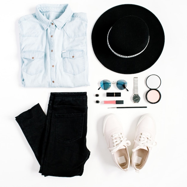 Photo beauty blog concept. woman clothes and accessories: hat, jeans, t-shirt, watches, sunglasses, sneakers on white background. flat lay, top view trendy fashion feminine background.