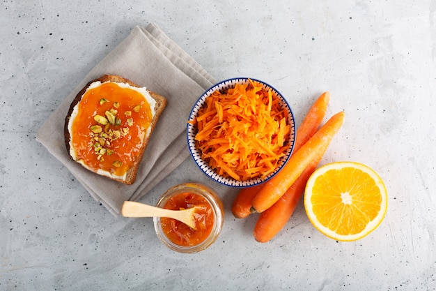 Варенье из моркови с апельсиновым соком на сером фоне