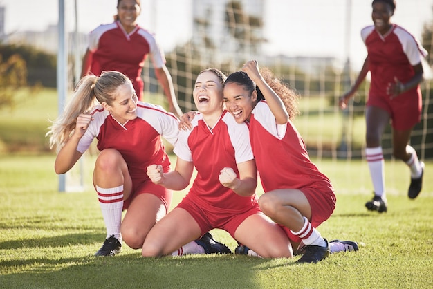 Photo celebrate winning and success female football players with fist pump and hurray expression soccer team girls or friends on a field cheering with victory sign celebrating win in a sports match