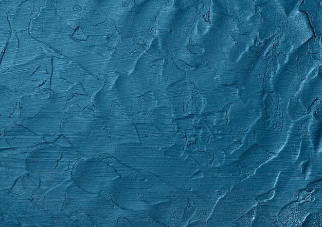 Фото Закройте вверх ярко-синий абстрактный фон текстуры неровной поверхности гранж с мазками штукатурки и краски