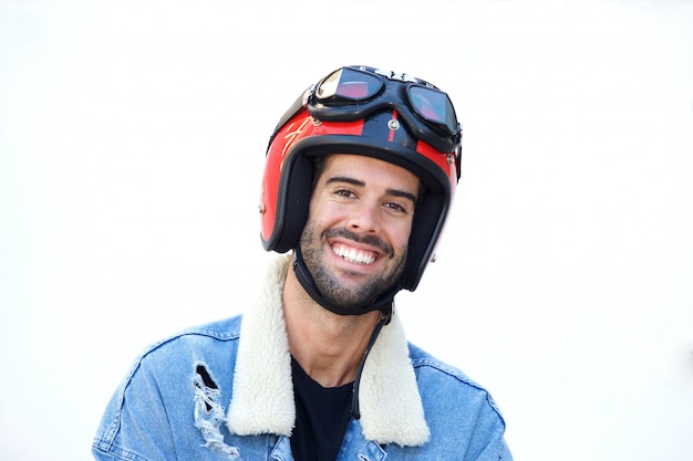 Close up smiling motorcyclist wearing helmet and jean jacket