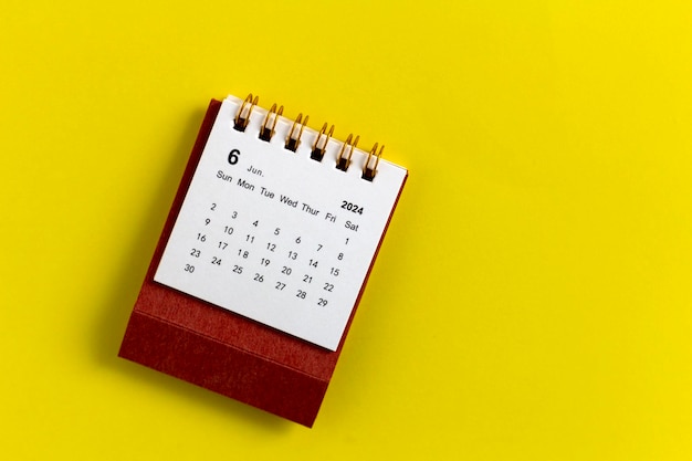 Desk calendar for June 2024 on a yellow background