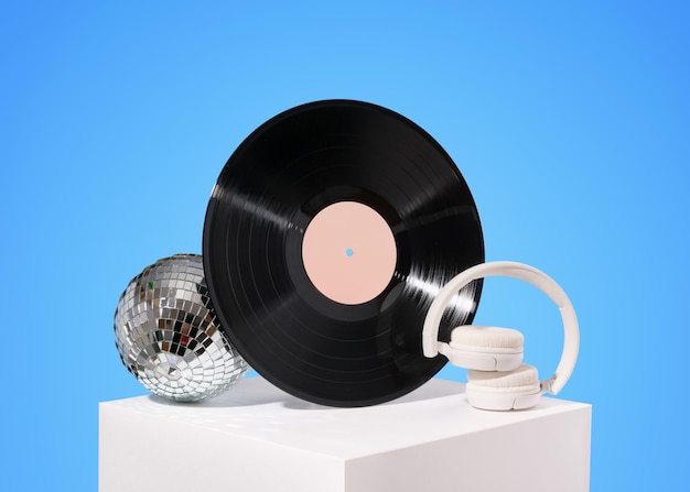 Photo disco and music idea vinyl record disco ball and white wireless headphones