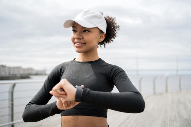 Фото Фитнес часы на руке пульс и калории женщина тренируется на улице активные упражнения