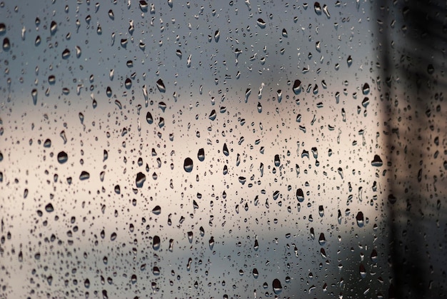 Photo full frame shot of wet glass window during rainy season
