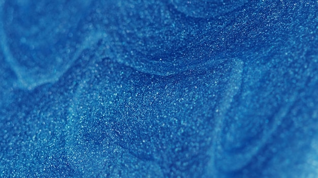 Блестящая жидкая краска потока синей влажной текстуры чернил волны
