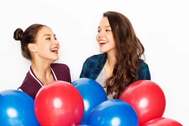 Photo happy teenage girls with helium balloons