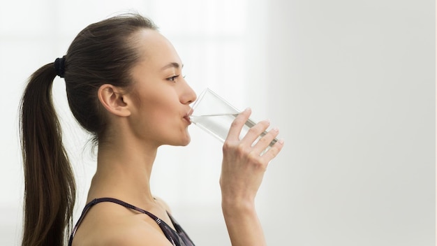 Healthcare Girl drinking clean mineral water side view