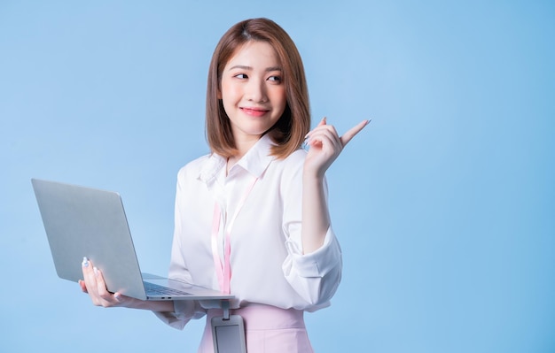 Photo image of young asian businesswoman on blue background