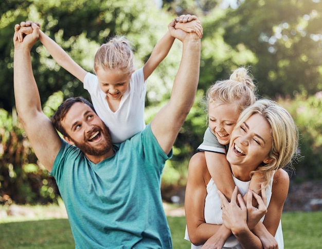 Photo love happy and family playing in a park laugh and relax while having fun together freedom kids and caring parents embracing and enjoying quality time with fun game outdoors cheerful and positive