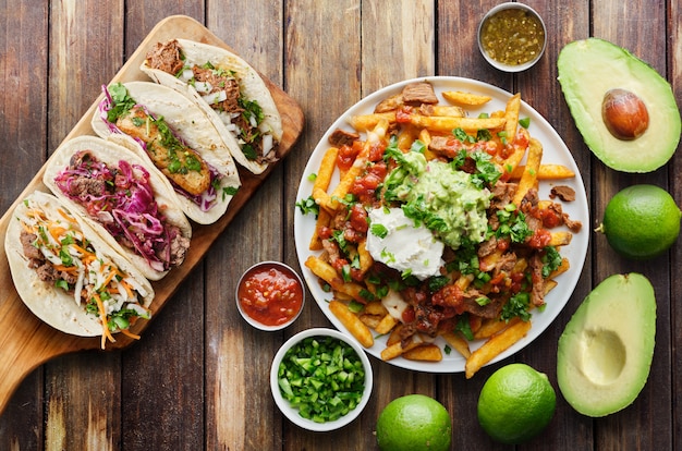 Photo mexican street tacos and carne asada fries in flat lay composition