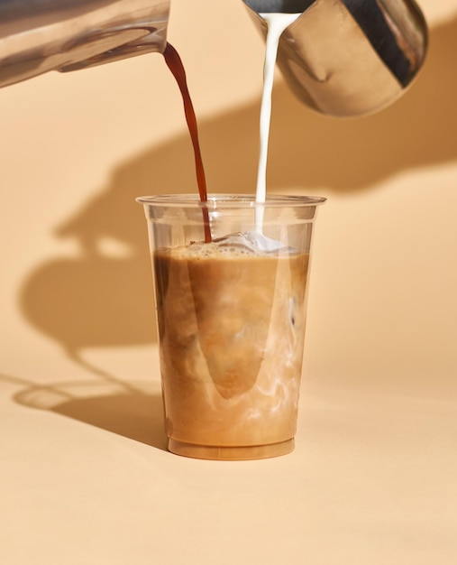Photo mockup of iced coffee milk in a plastic cup inside a cafe