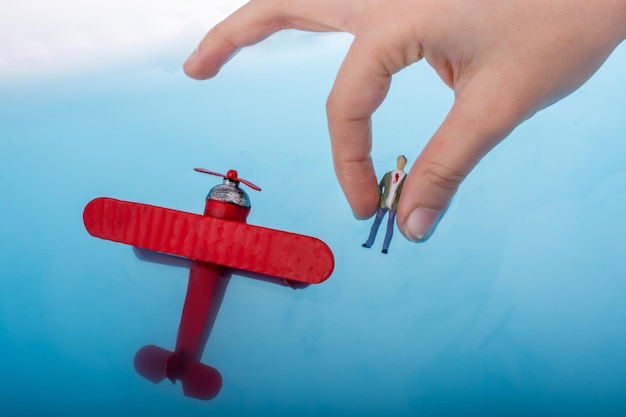 Photo model airplane and a man figurine in water