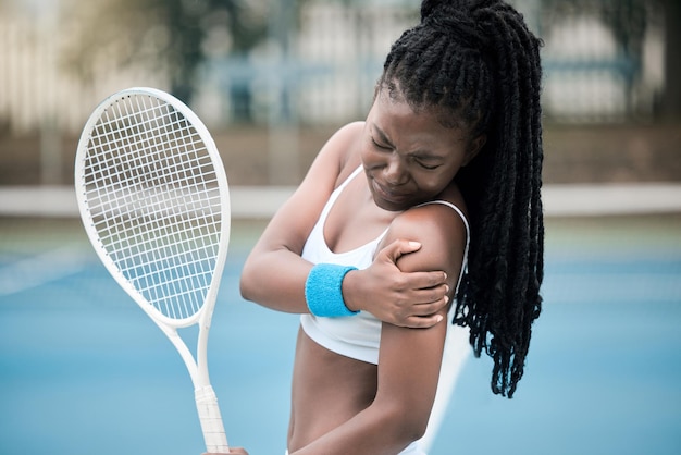 Muscle injury tennis game and black woman with emergency health problem during competition medical accident during sports and fitness training on court African athlete with arm pain during cardio