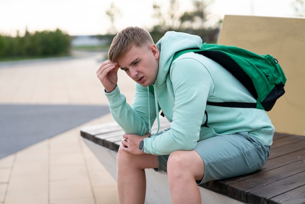 Photo portrait of sad upset frustrated depressed guy young handsome man is suffering from headache