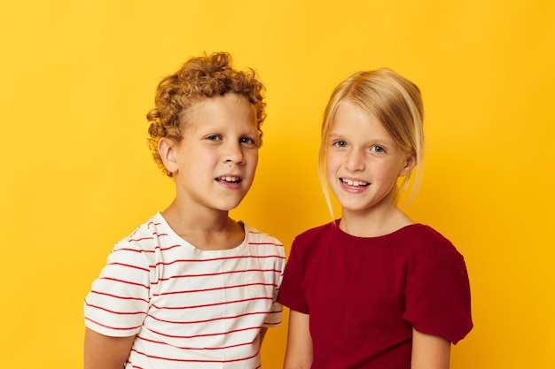 Photo portrait of sibling against yellow background