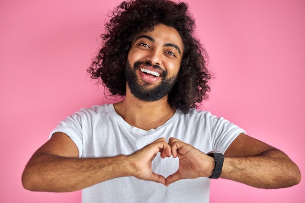 Photo portrait of smiling bearded man showing heart sign