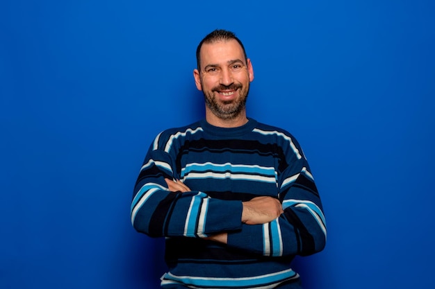 Foto portret van een man die tegen een blauwe achtergrond staat