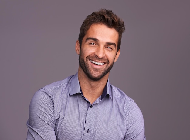 Photo rugged and manly studio shot of a handsome man against a gray background