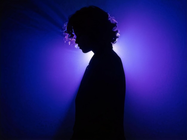 silhouette of a man with a purple hair on a dark background silhouette of a man with a purple h