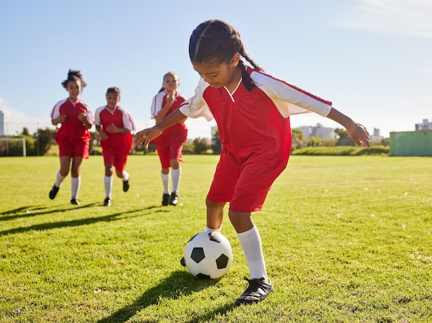 Тренировка по футболу или спорт и женская команда, играющая вместе с мячом на поле для тренировок