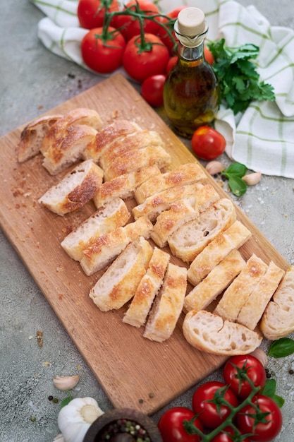 Sliced French bread baguette on wooden bread board