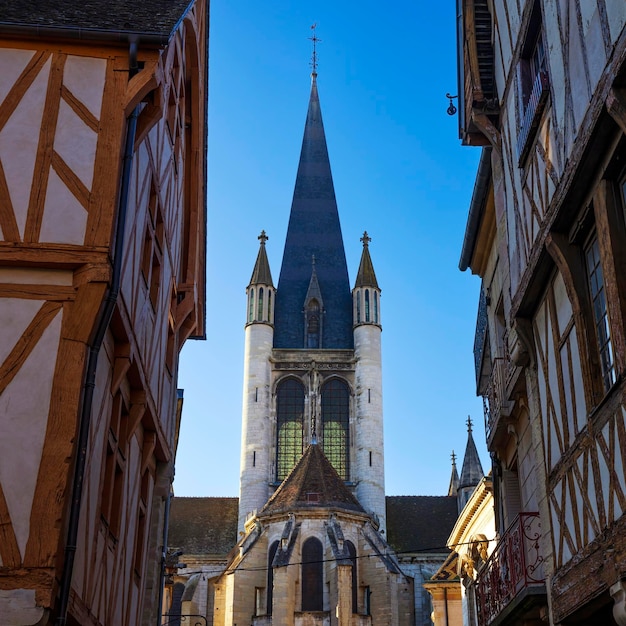 Street of Dijon with traditional houses and bell tower