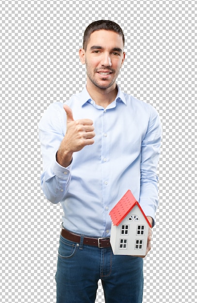 PSD satisfied young man holding a small house